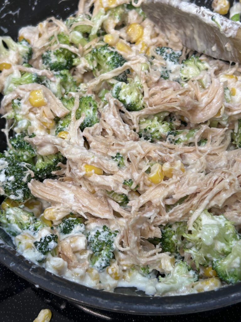 filling for chicken broccoli pie in a black saucepan.