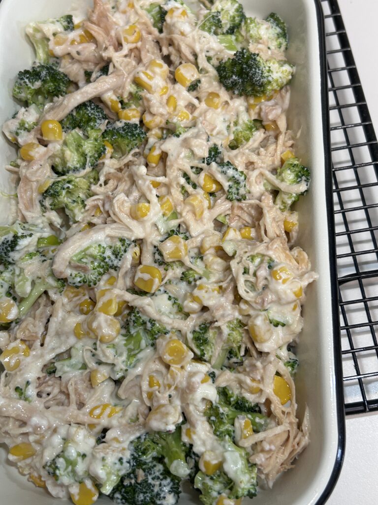 chicken corn and broccoli pie filling in a white casserole dish.