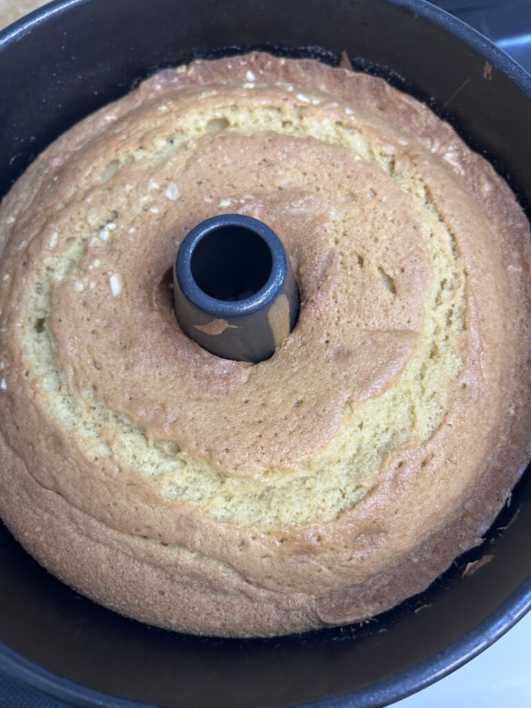 almond rum pound cake in a black cake tin. 