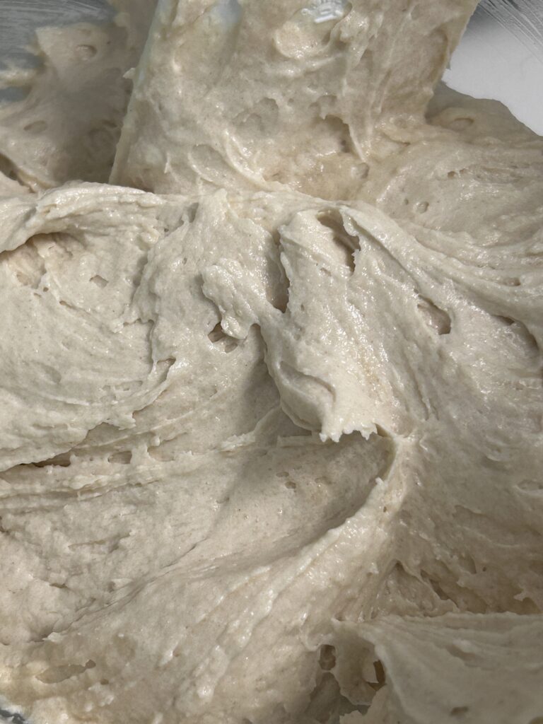 whipped cake batter for coffee cake in a metal bowl.