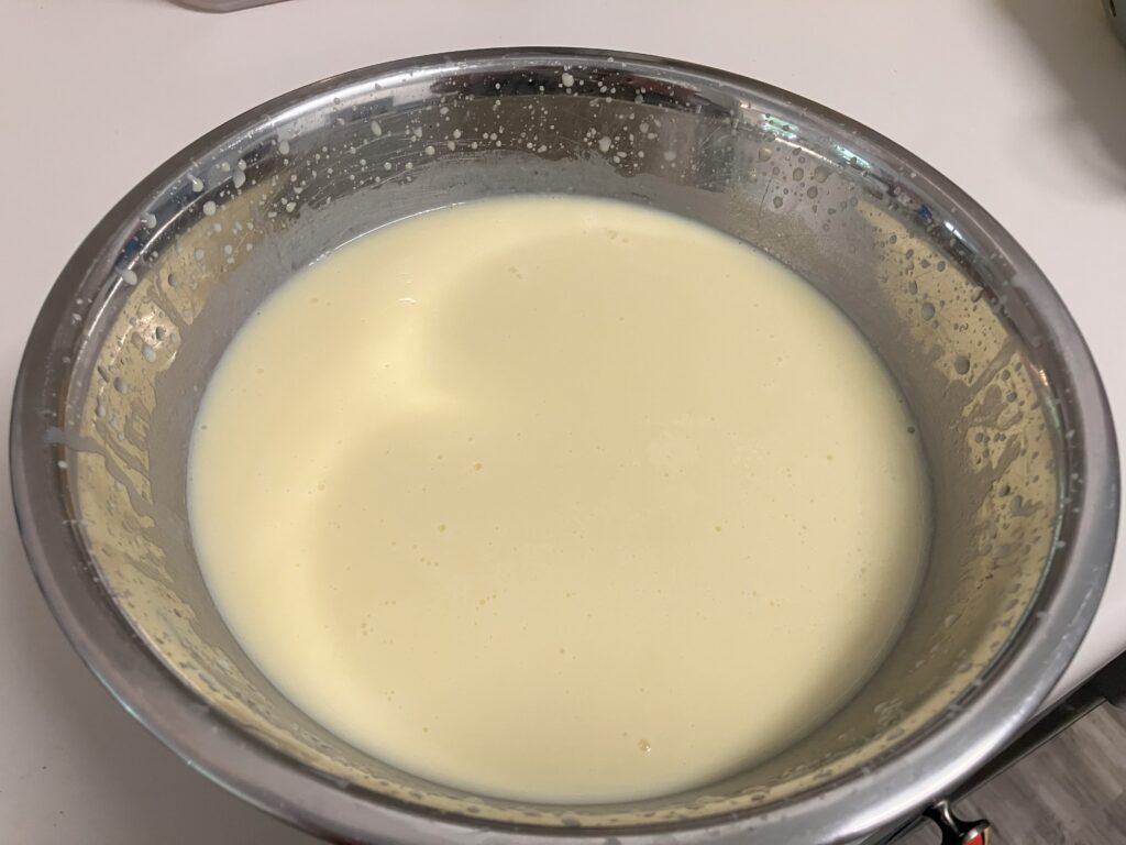 set vanilla pudding in a metal bowl.