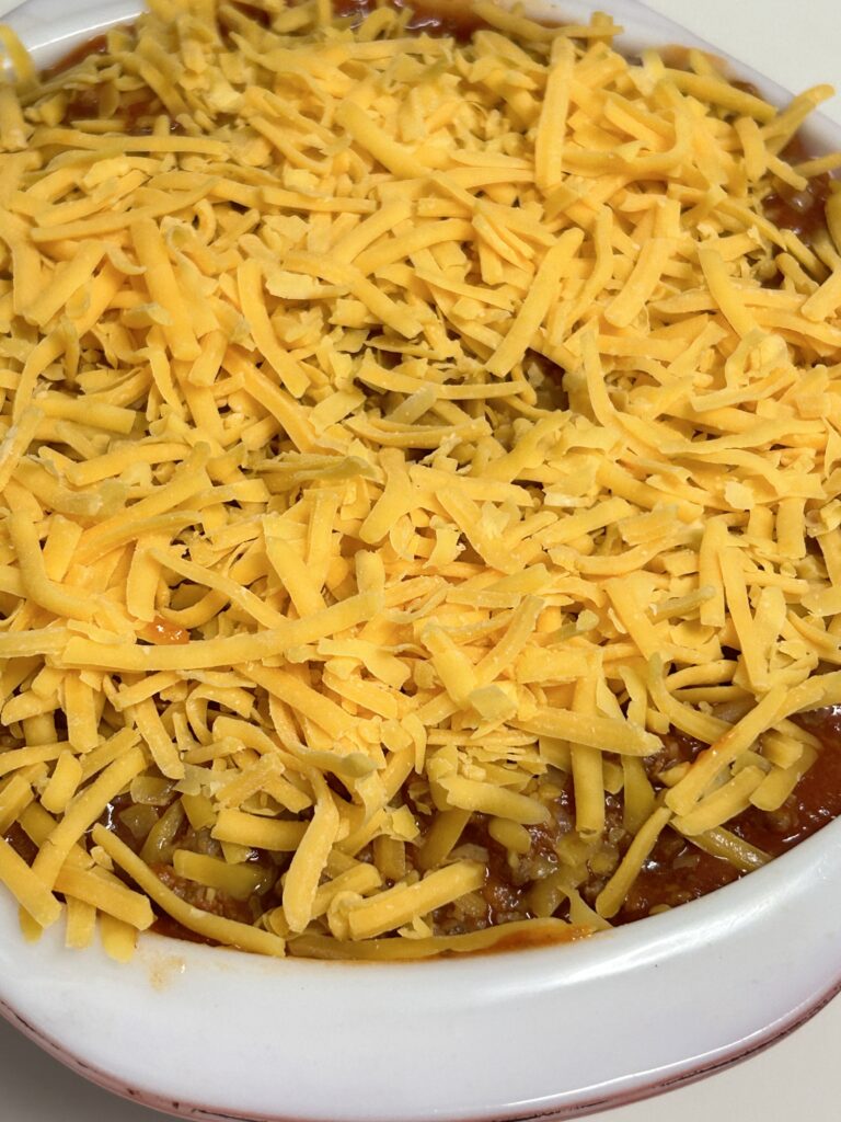 readily layered sloppy joe casserole sprinkled with shredded cheese.