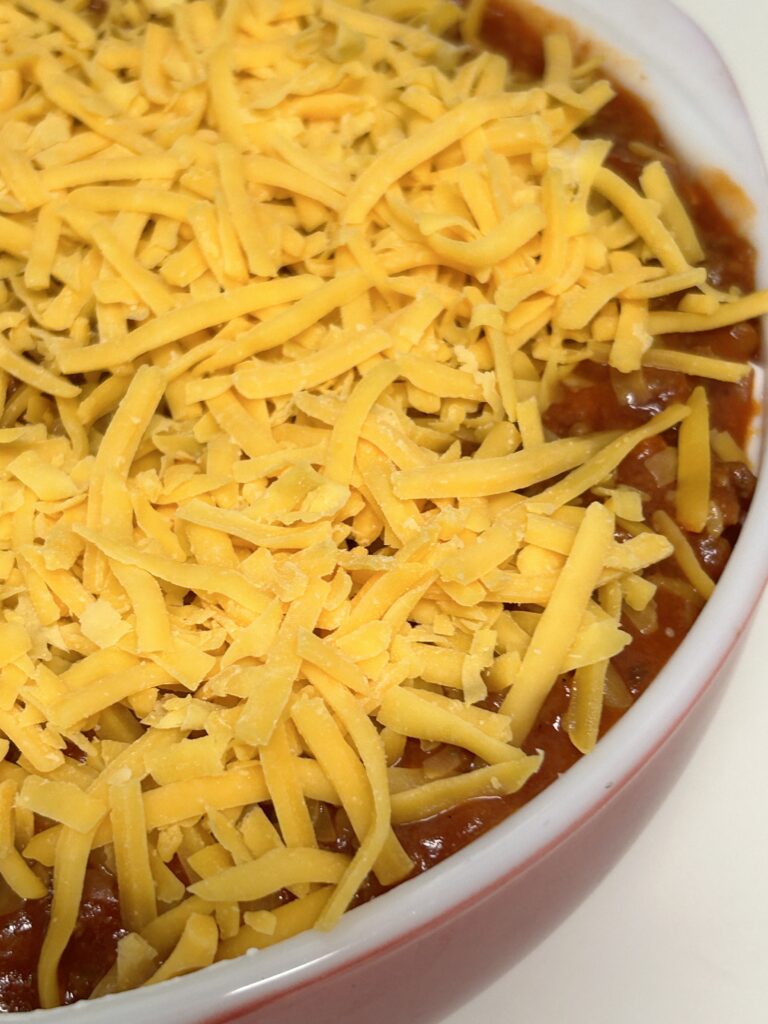 readily layered sloppy joe casserole sprinkled with shredded cheddat cheese.