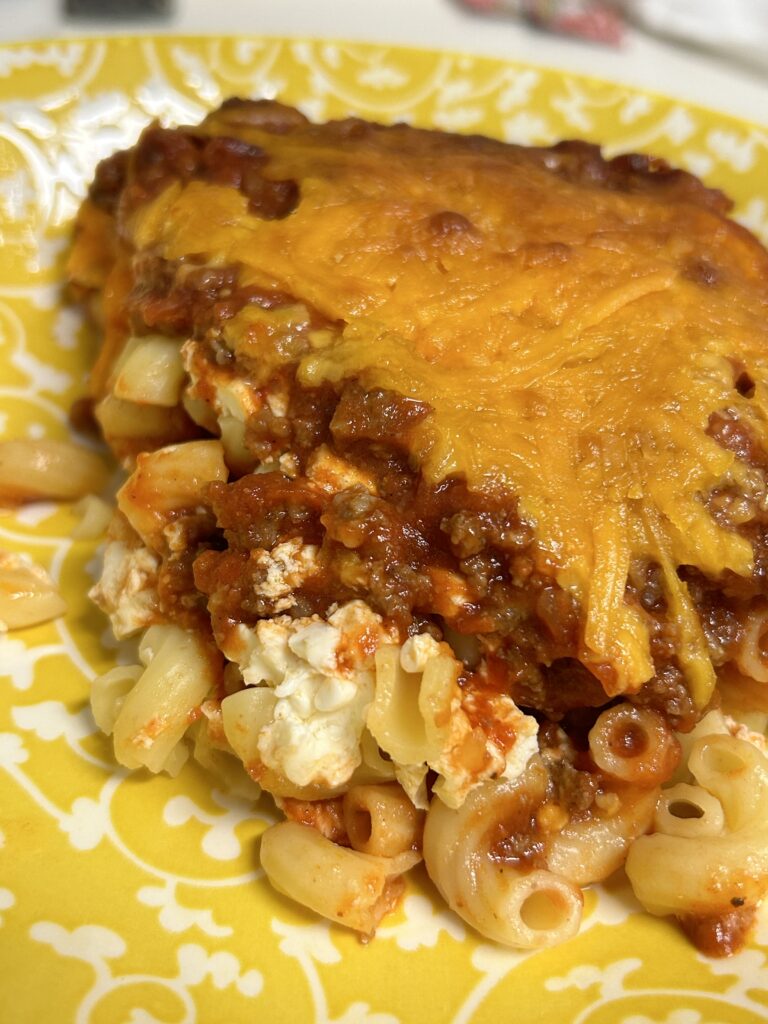 a serving of sloppy joe casserole on a yellow plate.