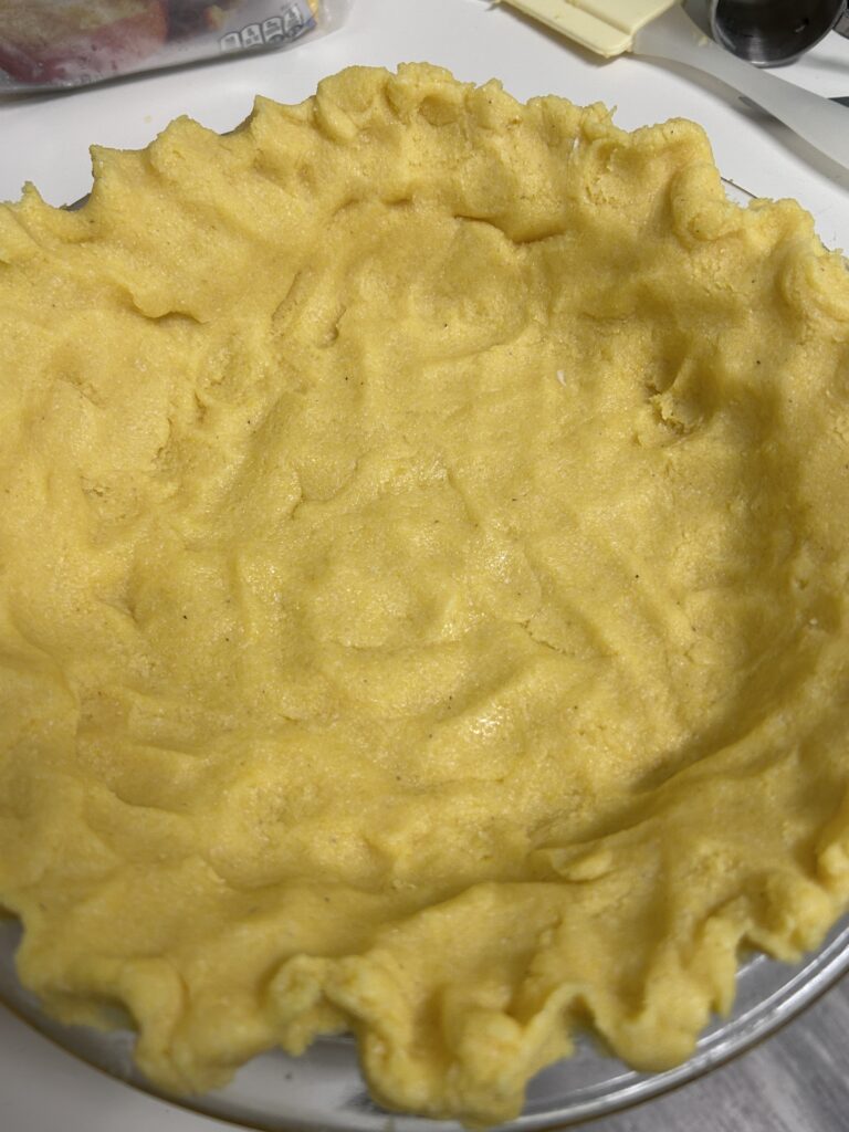 polenta pie crust in a pie dish. 
