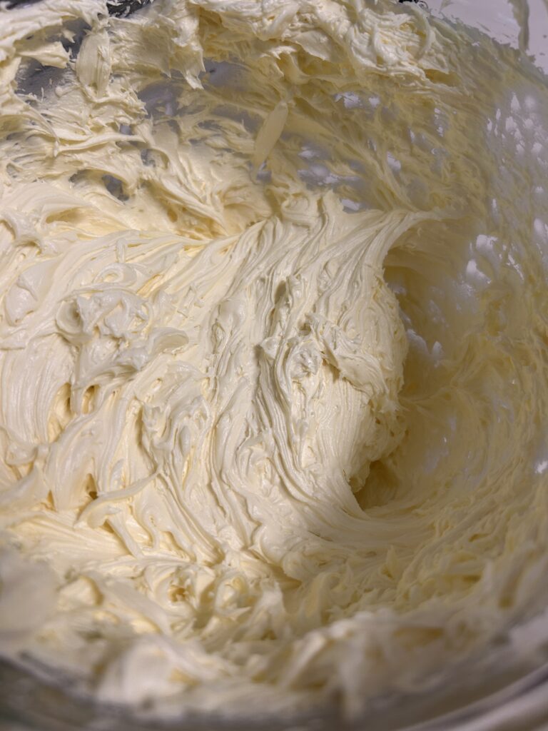 whipped lemon frosting in a glass bowl.