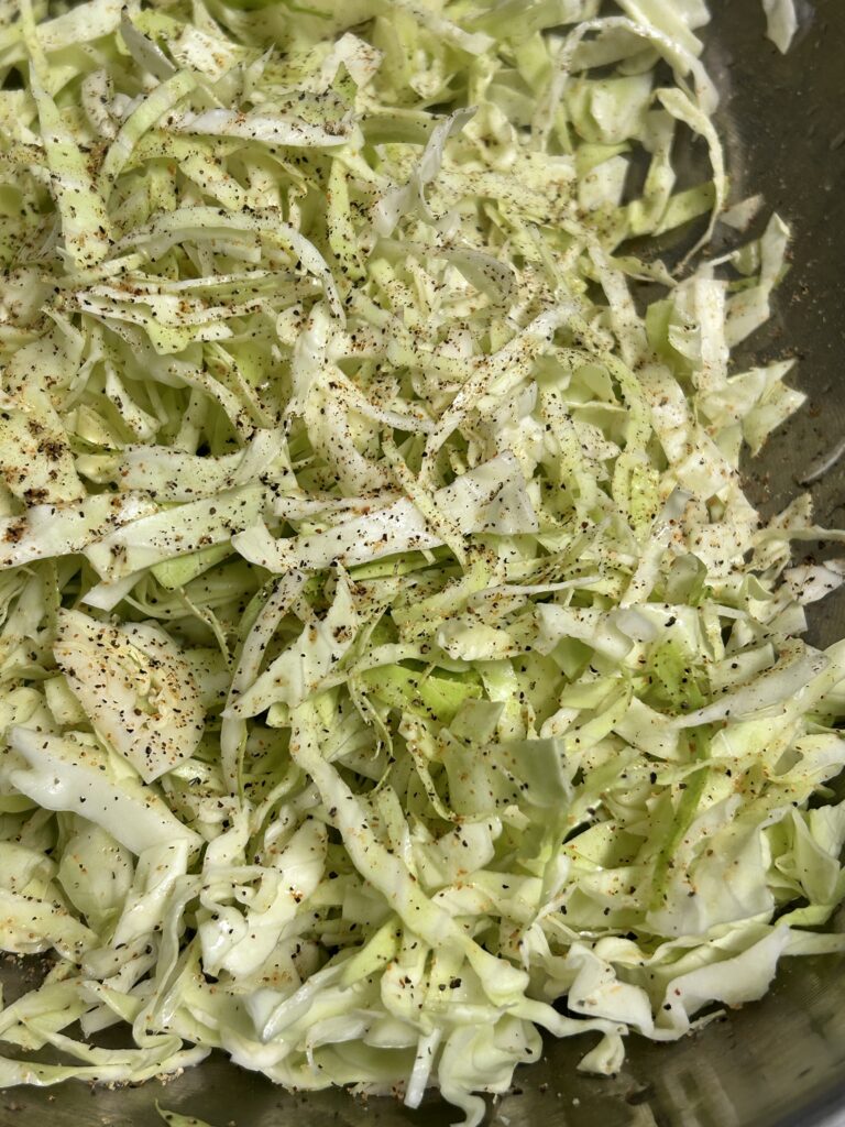 shredded cabbage in a metal bowl.