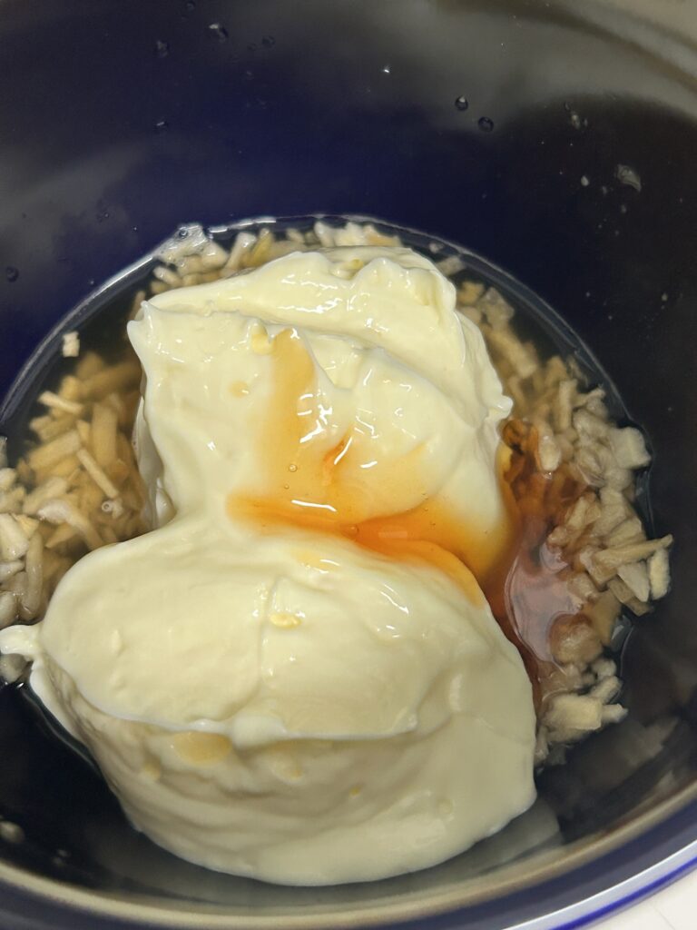 coleslaw dressing ingredients (vinegar, mayo and dried onions) in a small bowl.