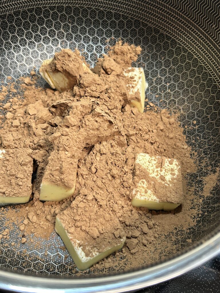 cocoa powder and butter in a saucepan.