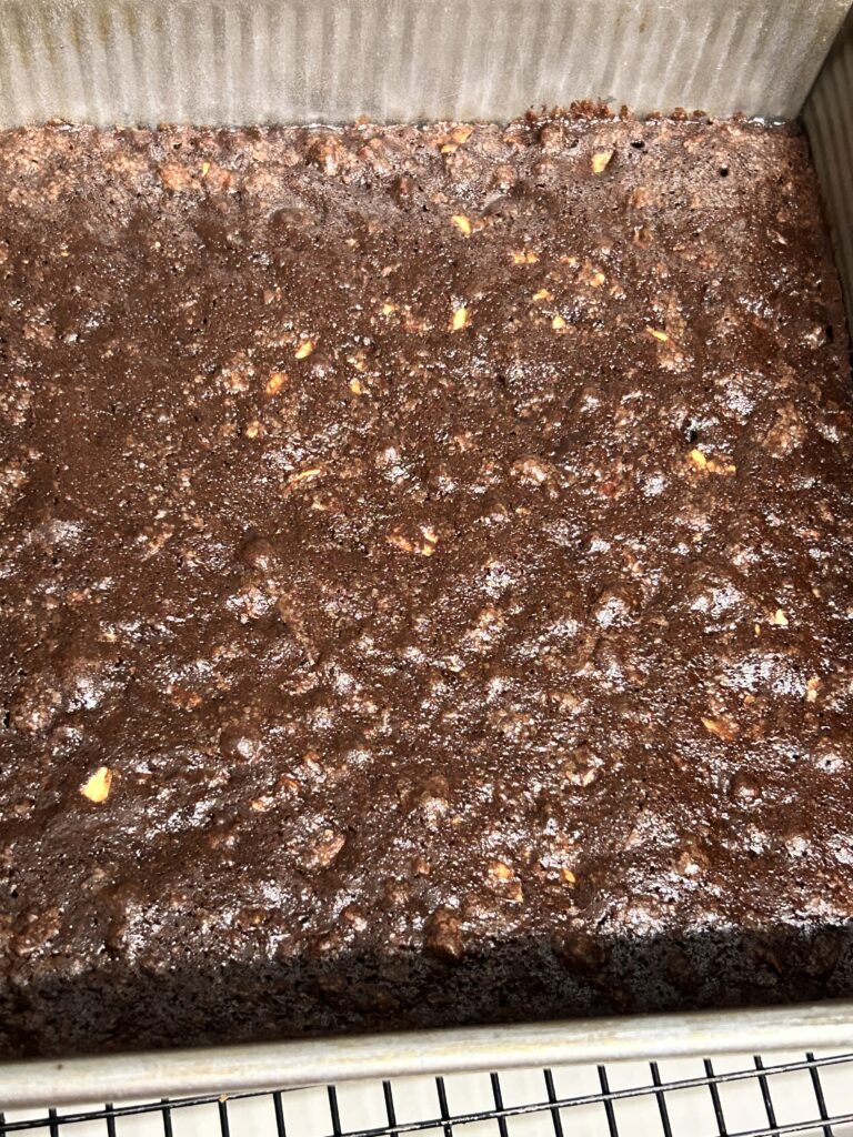 freshly baked mixed nut brownies cooling on a wire rack.