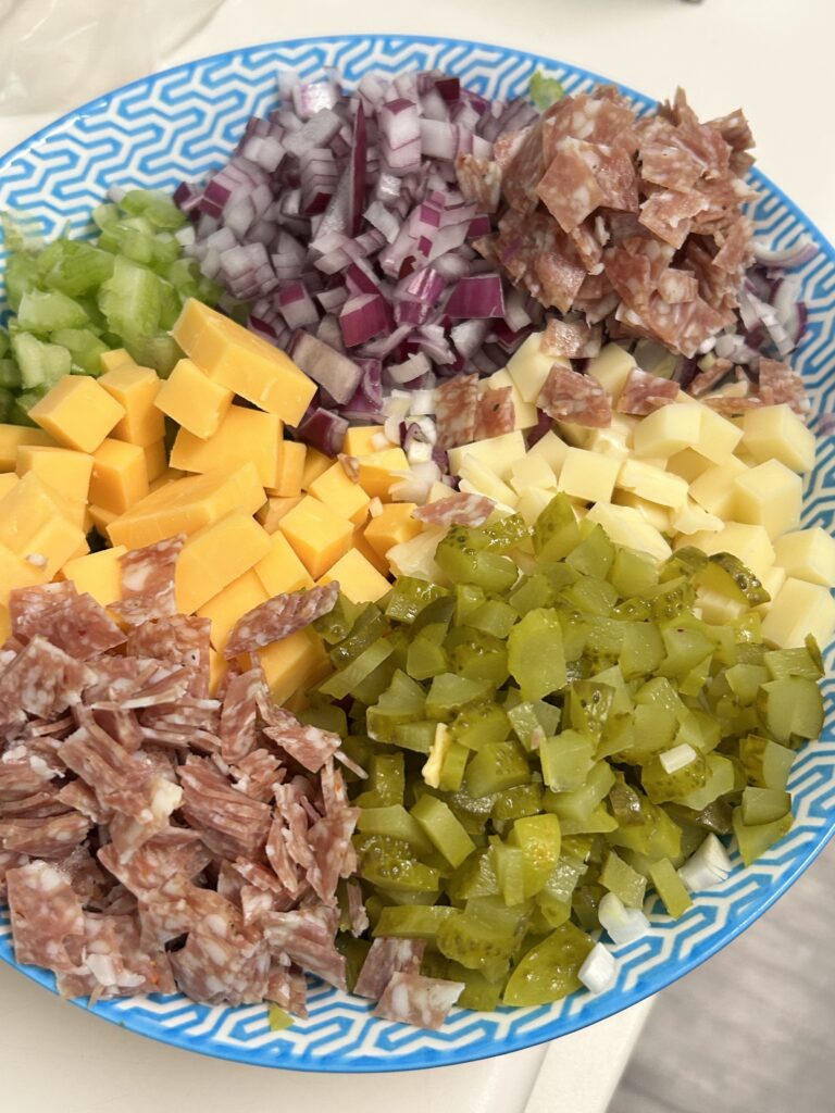 chopped up ingredients for macaroni salad in a small bowl.